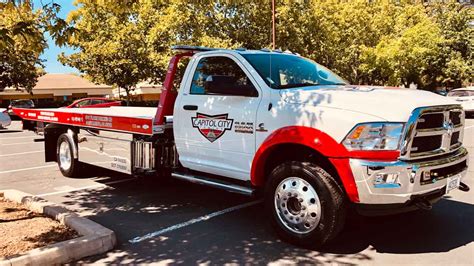 A rollback tow truck is a flatbed-style tow truck where the entire body inclines and slides back to pull the damaged vehicle up onto the bed. . Tow truck sacramento